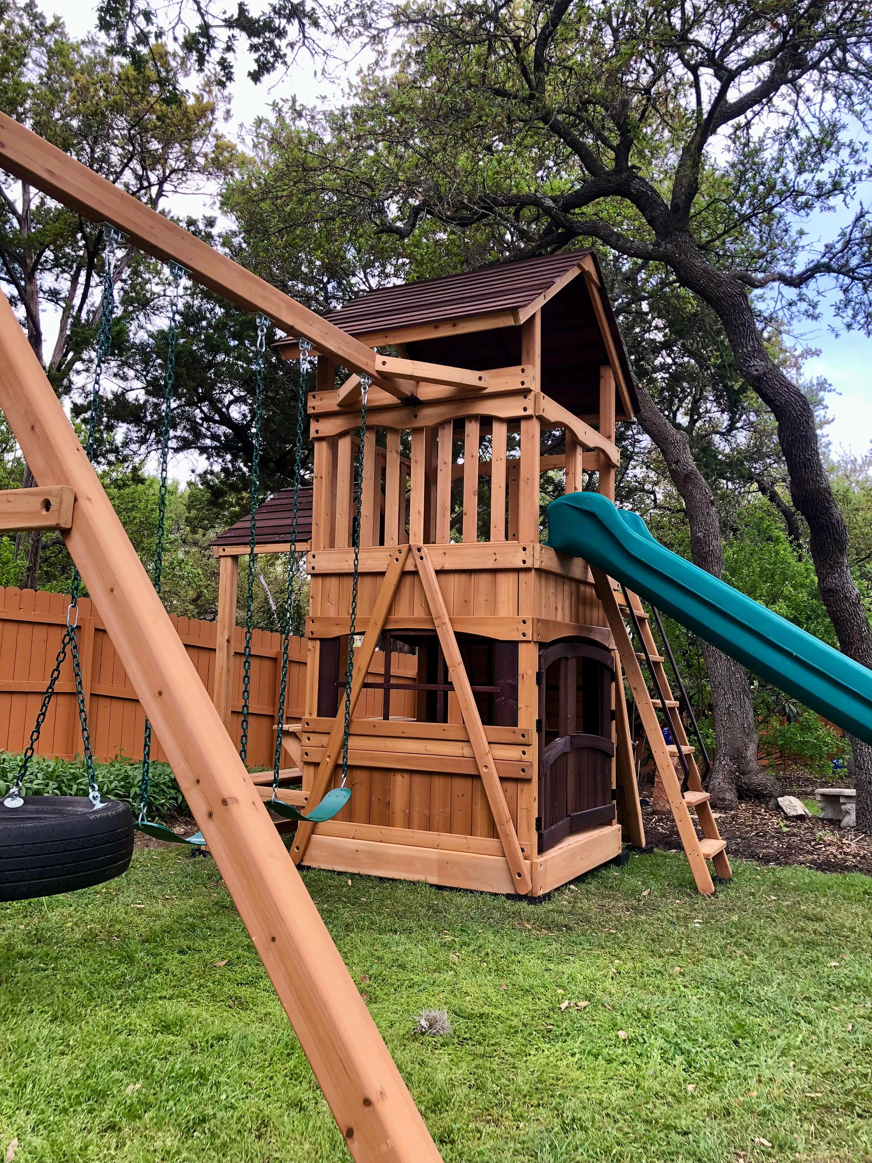 Backyard Adventures playset with slides, swings, and climbing accessories
